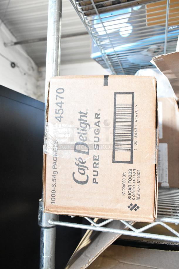 Two-tier lot featuring Diversey and Ajax cleaners, Gojo handwash, and a Café Delight pure sugar box on metal shelving.