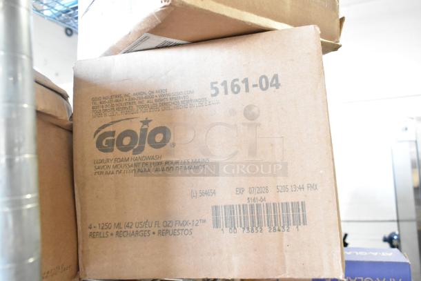 Two-tier lot with boxes of Gojo Foam Handwash, Diversey floor cleaners, and Ajax cleaner; visible Gojo label and expiration.