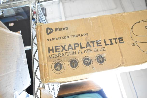 Brand new LifePro Hexaplate Lite vibration plate in blue, scratch and dent condition, boxed with therapeutic benefits noted.