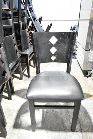 Set of 21 black dining chairs, features black seat cushions, diamond-patterned backrest, good condition.