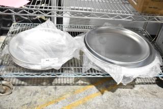 Brand new Avantco aluminum seafood trays, models 176SFD16TRY and 176SFD20TRY, on a shelf.