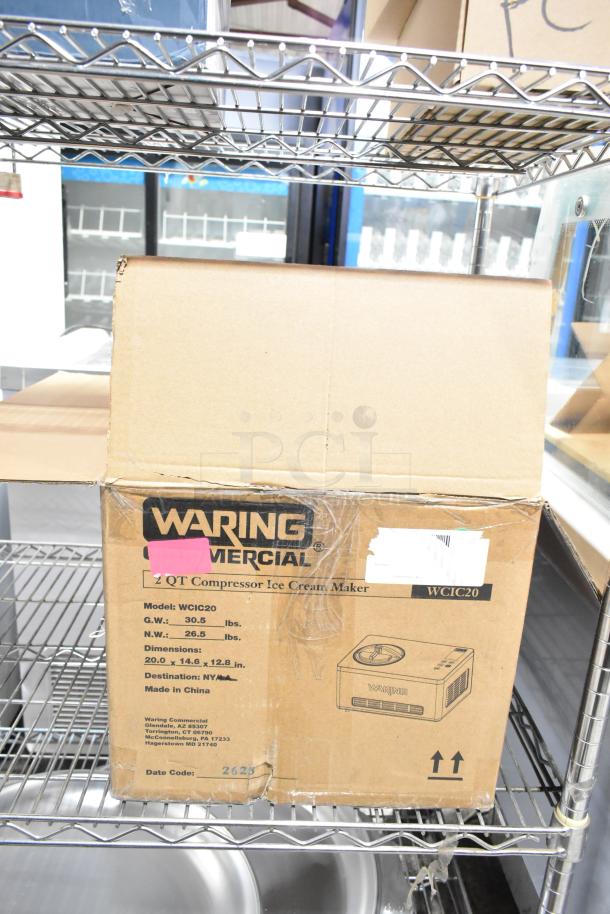 Brand new Waring WCIC20 2 Qt. Compressor Ice Cream Maker in box, 120V, with scratch and dent. Model, labels visible.