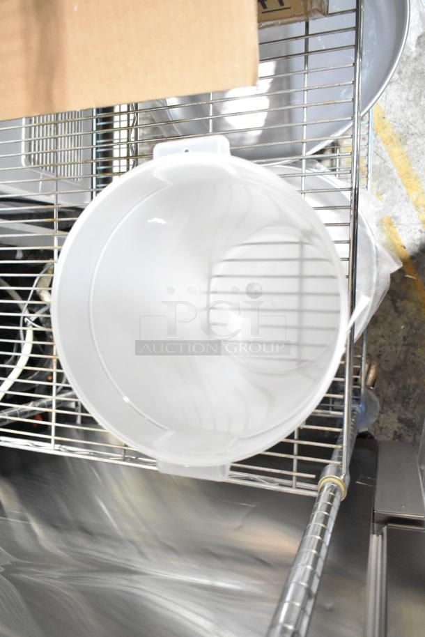 10 new scratch and dent kitchen items on wire rack including bowls, containers, basting cover, trays.