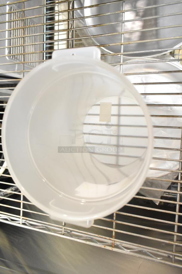 10 new scratch and dent items including bowls, food containers, and trays. Items displayed on metal rack.