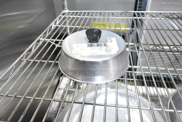 10 new scratch and dent items including basting cover on a metal shelf. Labels show product details and codes.