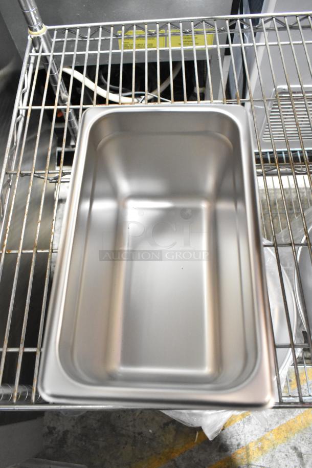 Stainless steel sediment tray on wire rack, brand new condition, part of 10 scratch and dent kitchen items auction.