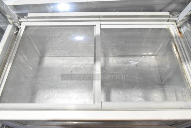 Commercial floor-style deli display case merchandiser, glass and metal, dual compartments, good condition.