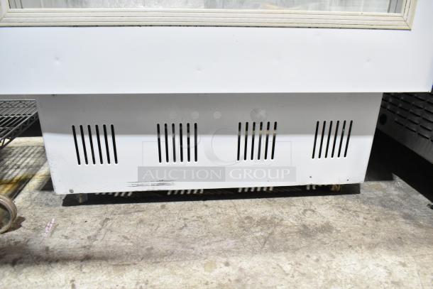 Commercial deli display case, floor style, white, visible vent slots, minor surface marks, suitable for food merchandising.