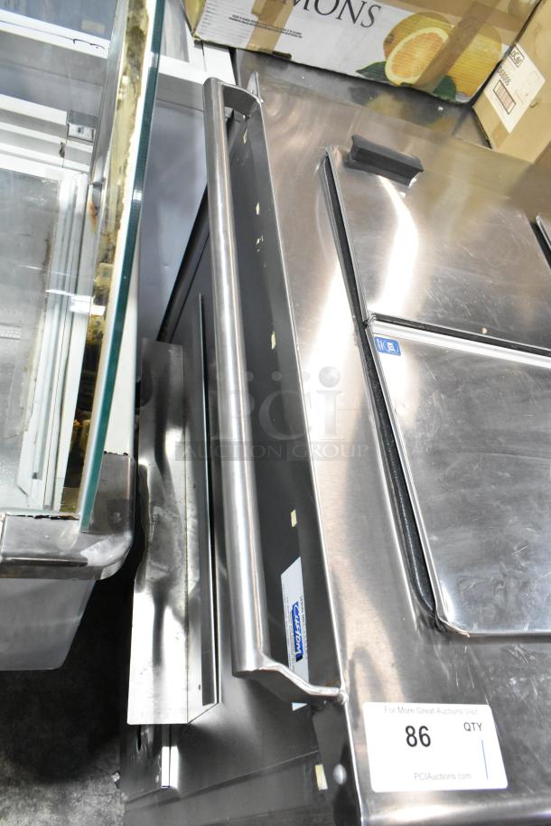 Commercial chest freezer with two center hinge lids, stainless steel design, integrated sink bay, PCI Auctions label visible.