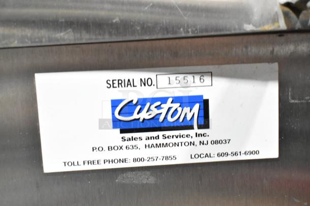 Commercial chest freezer with two center hinge lids and sink bay. Label reads: "Custom Sales and Service, Inc. Serial No. 15516."