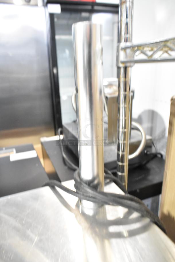 Commercial chest freezer with two center hinge lids and integrated sink bay, stainless steel, excellent condition.