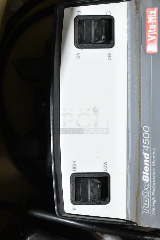 2 Vita-Mix VM0102/VM0103 blenders, no lids, TurboBlend 4500 model, 120 volts, 1 phase, control knobs visible.