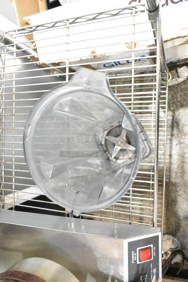 Two Vita-Mix VM0102/VM0103 blenders without lids, 120 volts, 1 phase, shown on a metal shelf; blades visible.