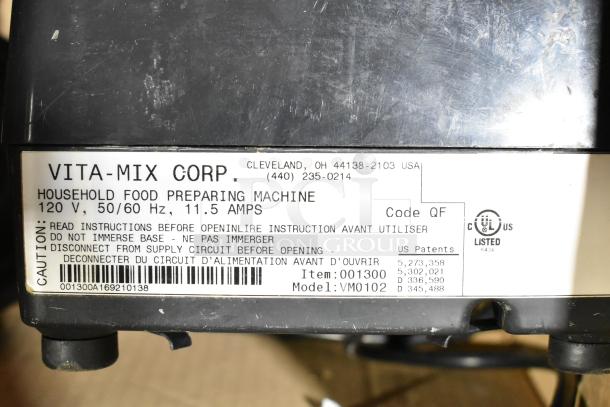 Two Vita-Mix blenders, models VM0102/VM0103, no lids. 120V, 1 phase. Label shows specs and safety instructions.