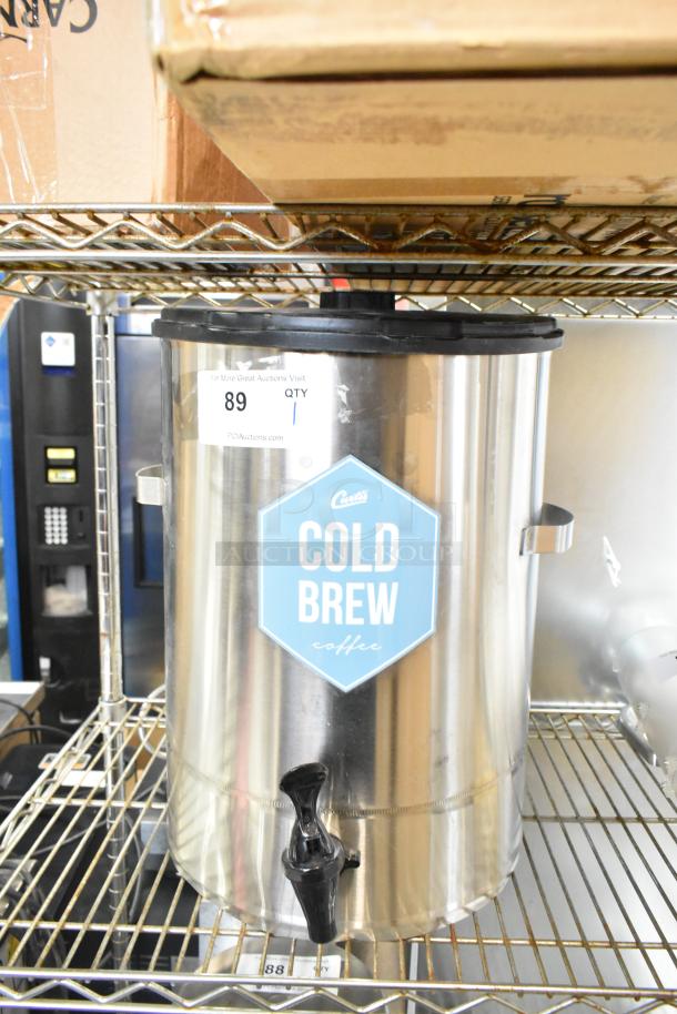 Curtis TC-7H Beverage Holder Dispenser, stainless steel, labeled "Cold Brew," with black spigot. Auction tag visible.
