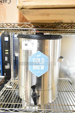 Curtis TC-7H Beverage Holder Dispenser, stainless steel, labeled "Cold Brew," with black spigot. Auction tag visible.