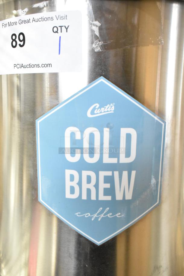 Curtis TC-7H Beverage Holder Dispenser, stainless steel, labeled for cold brew coffee, auction tag visible.