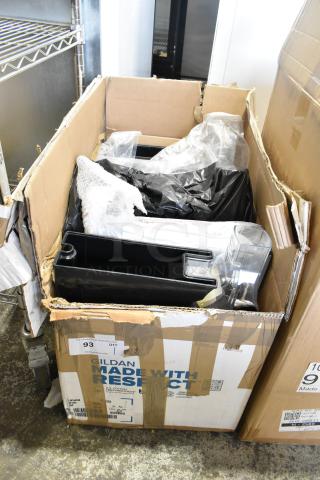 Lot of various items, including dry food dispenser hoppers, in a cardboard box. Box shows labels and signs of wear.