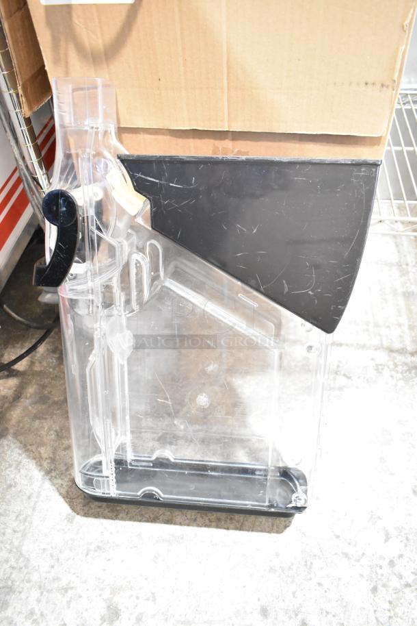 Clear dry food dispenser hopper with black top and handle, minor scratches visible.筀