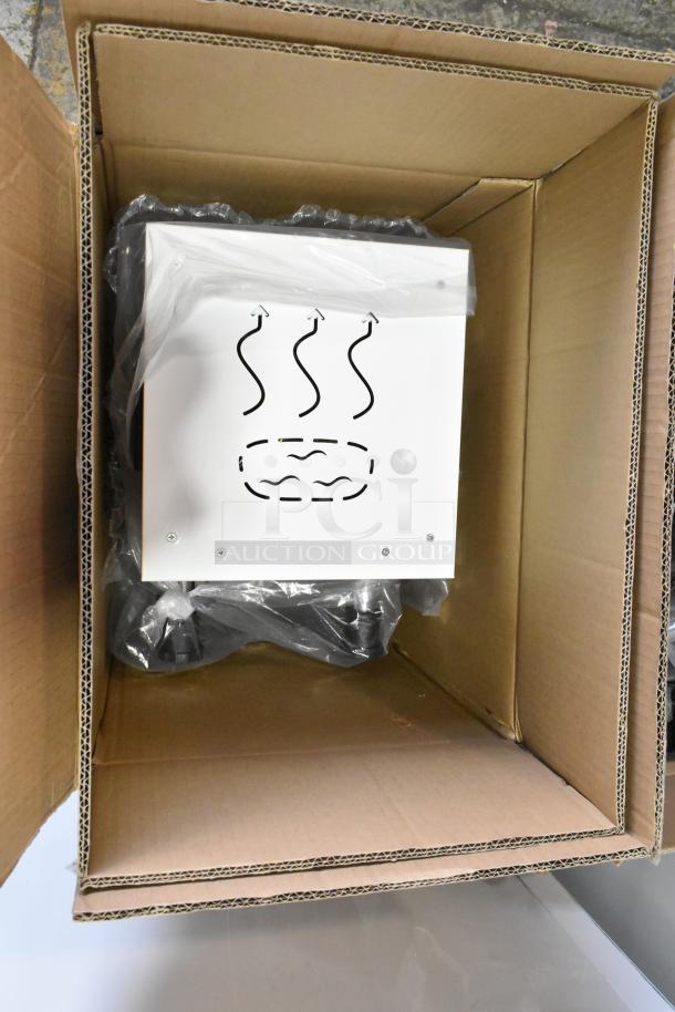 Brand new commercial steam milk frother in box, showing minor scratches and dents. Packaged with protective plastic.