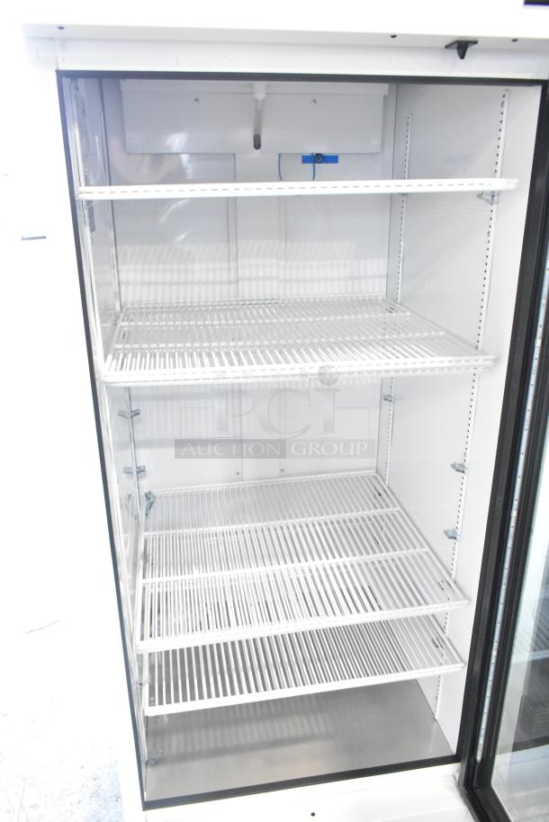 2021 True TSCI-600R-G-PH commercial cooler merchandiser, single glass door, 115 volts, three adjustable shelves, excellent condition.