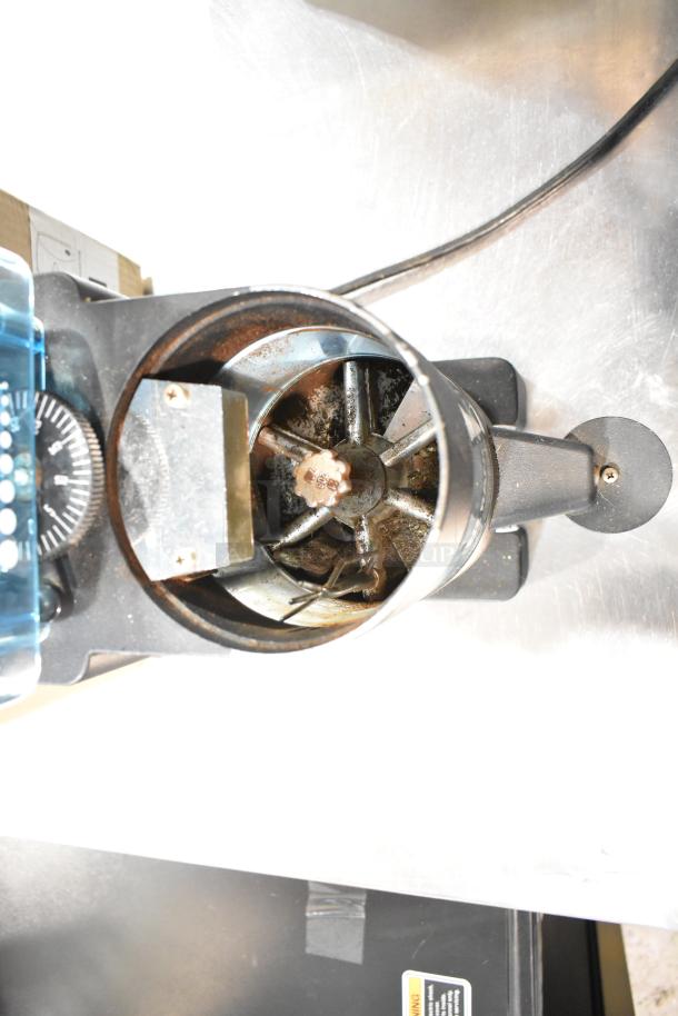 Rancilio MD 50/AT espresso grinder, visible wear, metal components. 110V, 1 phase. Ideal for commercial use.