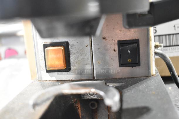 Rancilio MD 50/AT espresso grinder showing control switches and exterior wear, 110V, 1 phase, commercial use.