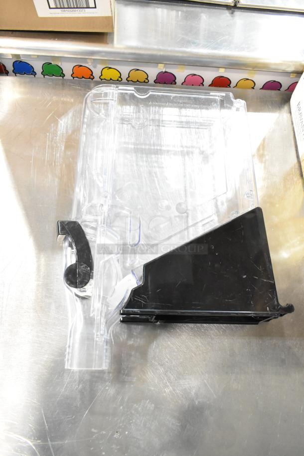 Clear plastic and black poly dry dispenser hopper with handle. Good condition, used for dry goods dispensing. Set of 7.