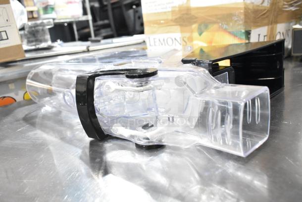 Seven Poly Dry Dispenser Hoppers, transparent with black accents, in good condition, ideal for organized bulk storage.