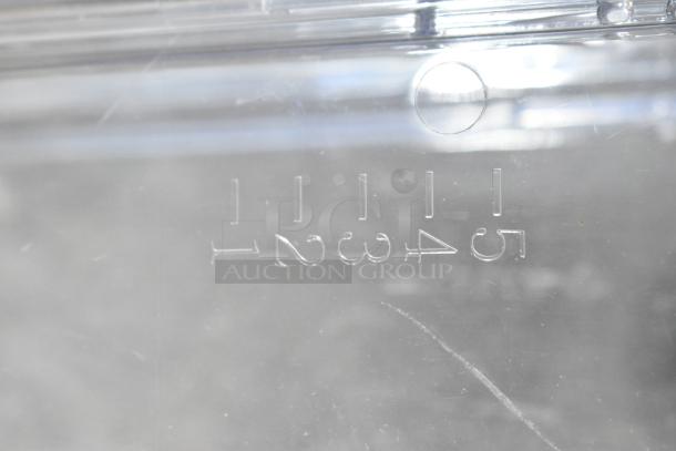 Clear poly dry dispenser hopper with embossed numerical markings from 1 to 5 for measurement. Slight surface scratches.