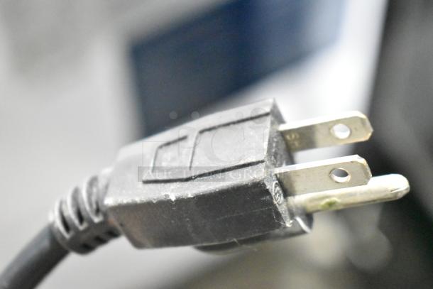 Close-up image of a power plug, which is likely part of the Dukers WD-700Y Commercial Chest Freezer Merchandiser, 115 Volts, 1 Phase.