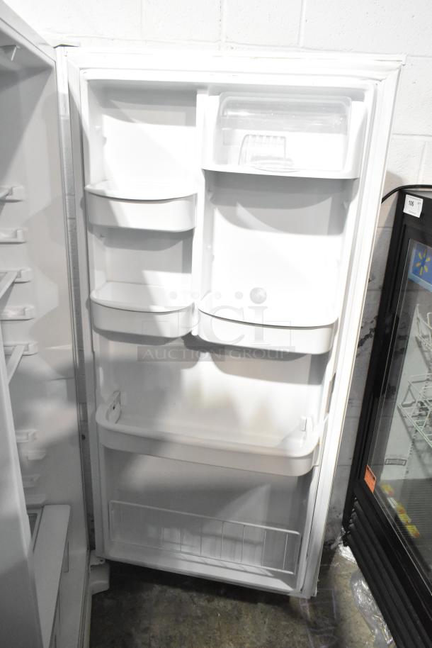 Whirlpool WRR56X13FW02 reach-in cooler, 115 volts, 1 phase. Clean interior with multiple shelves and compartments.