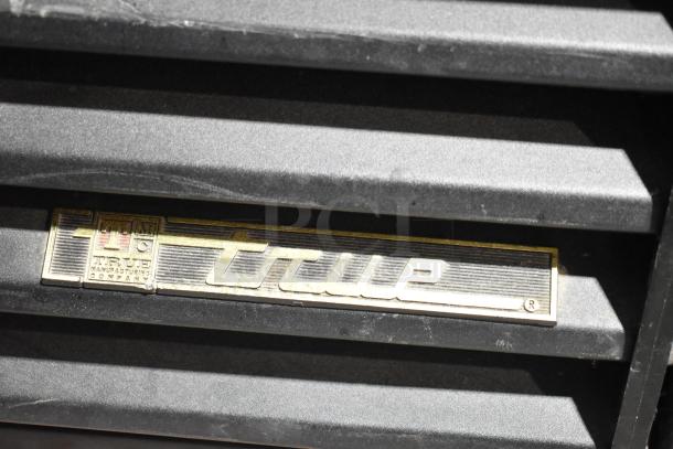 True logo on a GDM-41SL-54-LD commercial cooler merchandiser. Black panel in good condition.