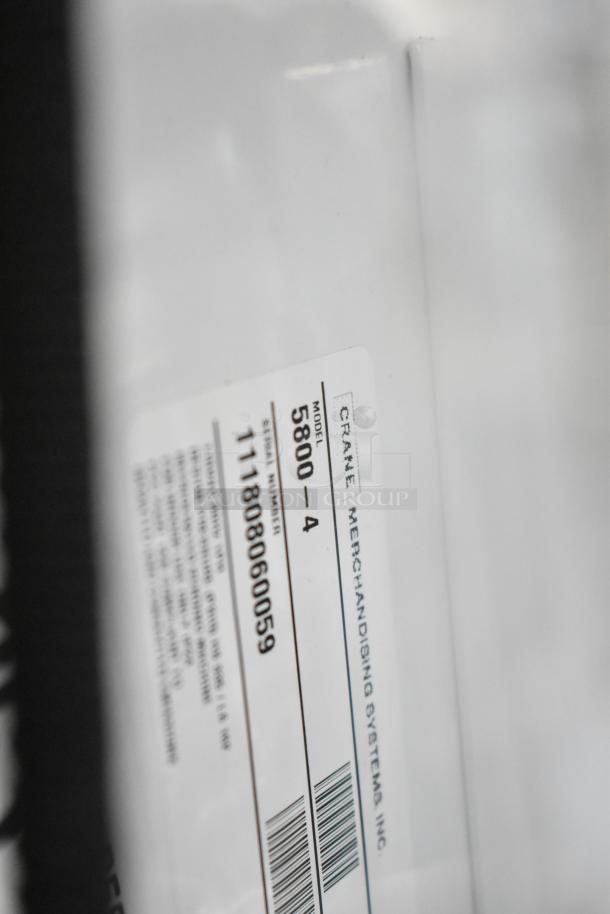 Crane 5800-4 vending machine with bill acceptor tag. Model and serial number displayed. 115V, 1 Phase.