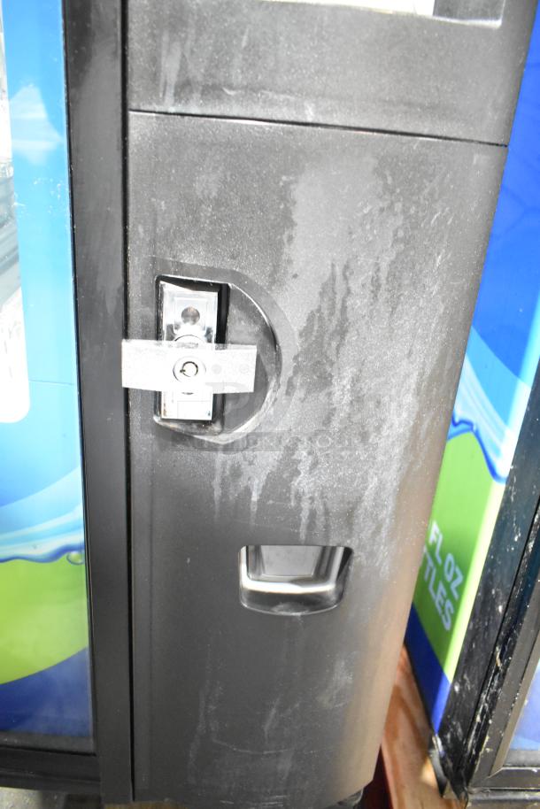 Crane 5800-4 metal beverage vending machine with bill acceptor. Features robust lock mechanism. Condition shows wear.