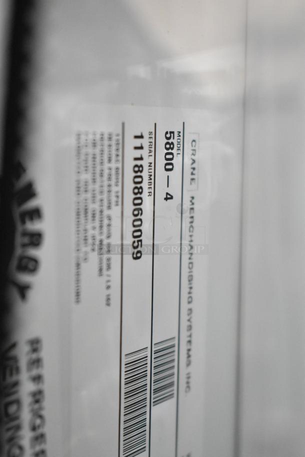Crane 5800-4 metal vending machine detail showing model and serial number on label. Includes bill acceptor, 115V, 1 phase.