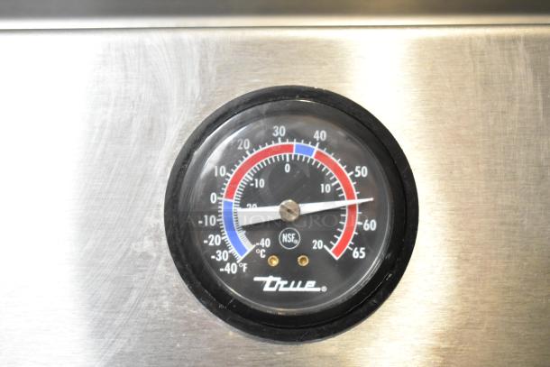 Thermometer on a 2016 True T-19F Commercial Single Door Reach-In Freezer. Displays temperature in Celsius and Fahrenheit.