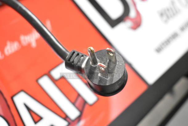 2019 True GDM-26F-HC Cooler plug, 115V, 1 Phase; black power cord against branded backdrop.