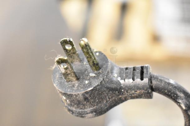 Close-up of a worn electrical plug from a 2016 True T-19F Commercial Freezer, indicating signs of use.