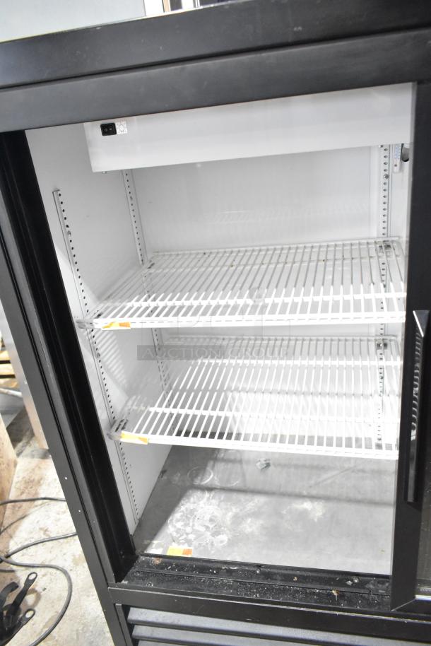 True GDM-41SL-48-HC-LD cooler merchandiser with two glass doors, interior shelving, 115 volts, used condition.
