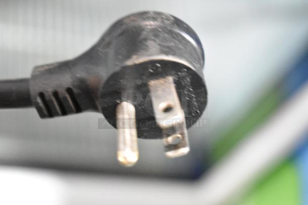 A close-up of a power plug for a 2021 True TSCI-600R-G-PH commercial cooler, 115 volts, 1 phase.