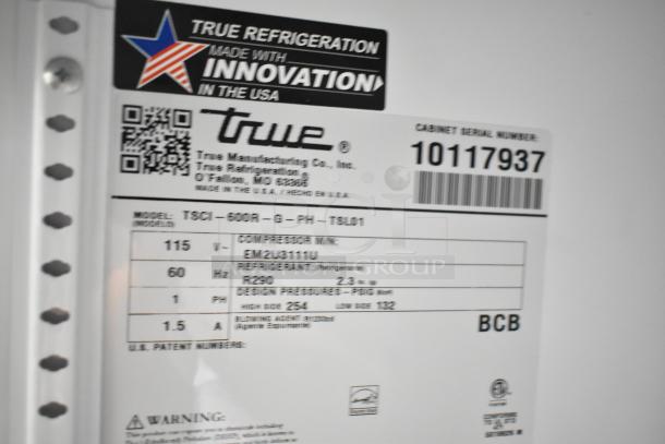 Label of a 2021 True TSCI-600R-G-PH cooler displaying model, serial number 10117937, voltage 115, and refrigerant type R290.