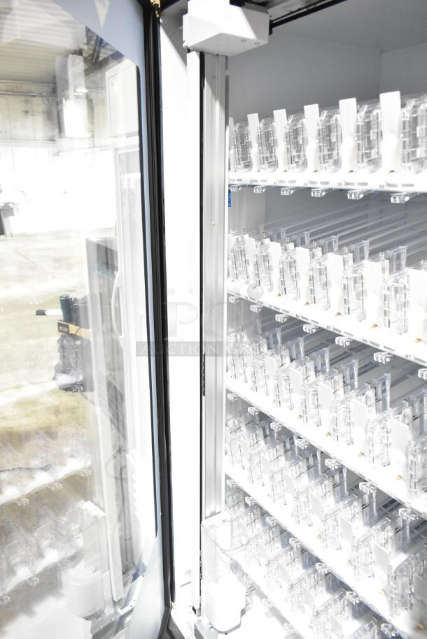 Crane 5800-4 metal commercial vending machine with bill acceptor, shelves for bottled drinks, open door view.