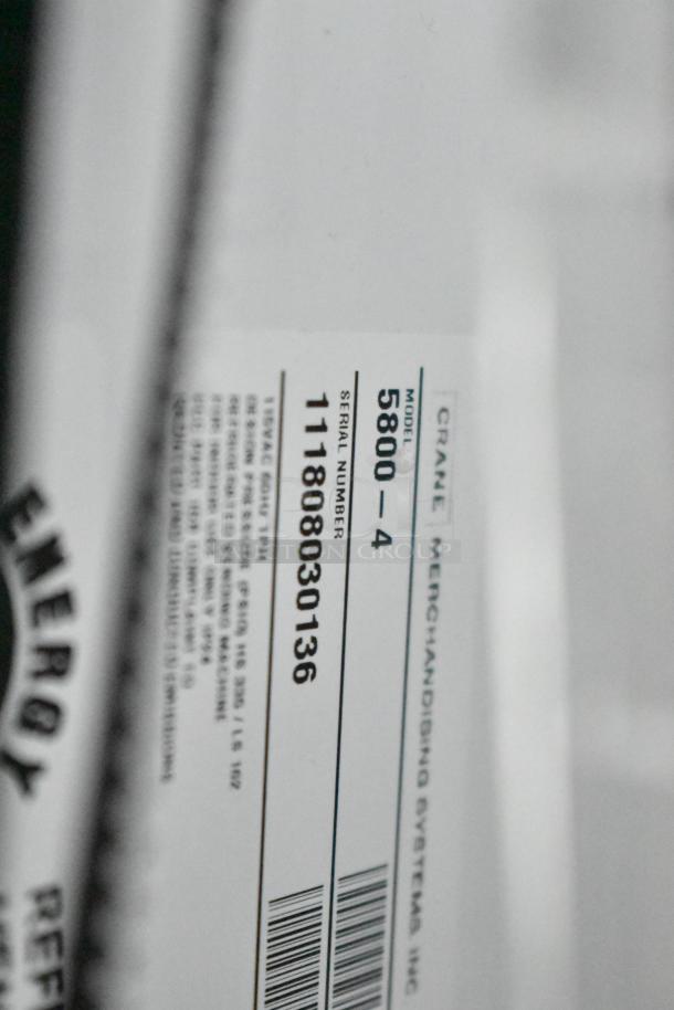 Crane 5800-4 metal drink vending machine label showing model and serial number, 115 volts, 1 phase.