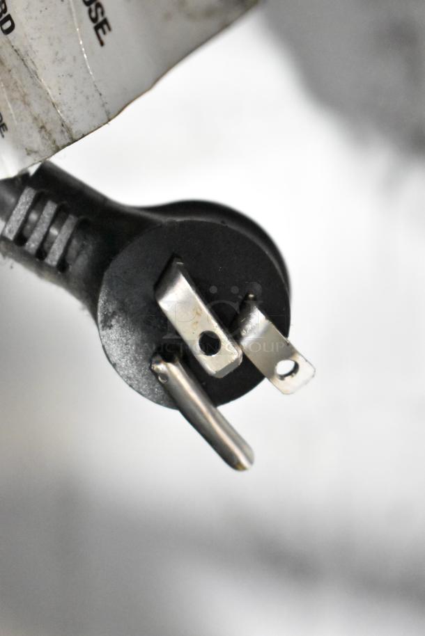 Crane 5800-4 metal vending machine plug, 115V, 1 phase. Close-up showing wear on power cord label.