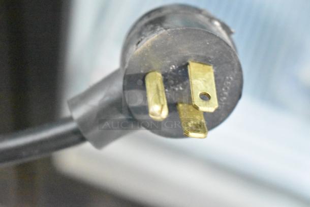 Close-up of a plug from Habco SE12 Commercial Single Door Reach In Cooler Merchandiser, 115 Volts, 1 Phase.