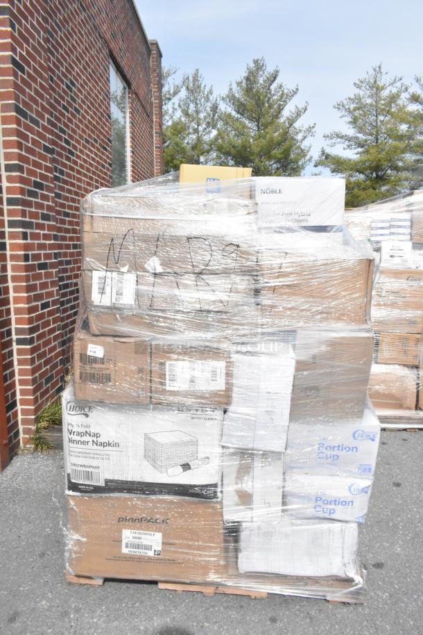 Pallet of various scratch and dent items, including hot cups, takeout bags, teaspoons; wrapped in plastic, some labels visible.