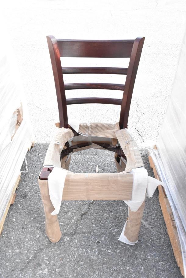 Lancaster Table & Seating mahogany ladder back chair with black vinyl seat, new condition, seat detached, protective wrap.