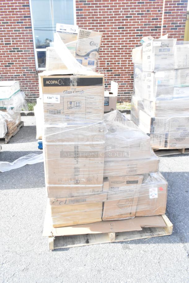 Pallet of 20 assorted scratch and dent items, including fry pan and deep dish pizza pans, wrapped in plastic. Tags indicate “Acopa Glass Carafe” and “Choice Paper Cups.”