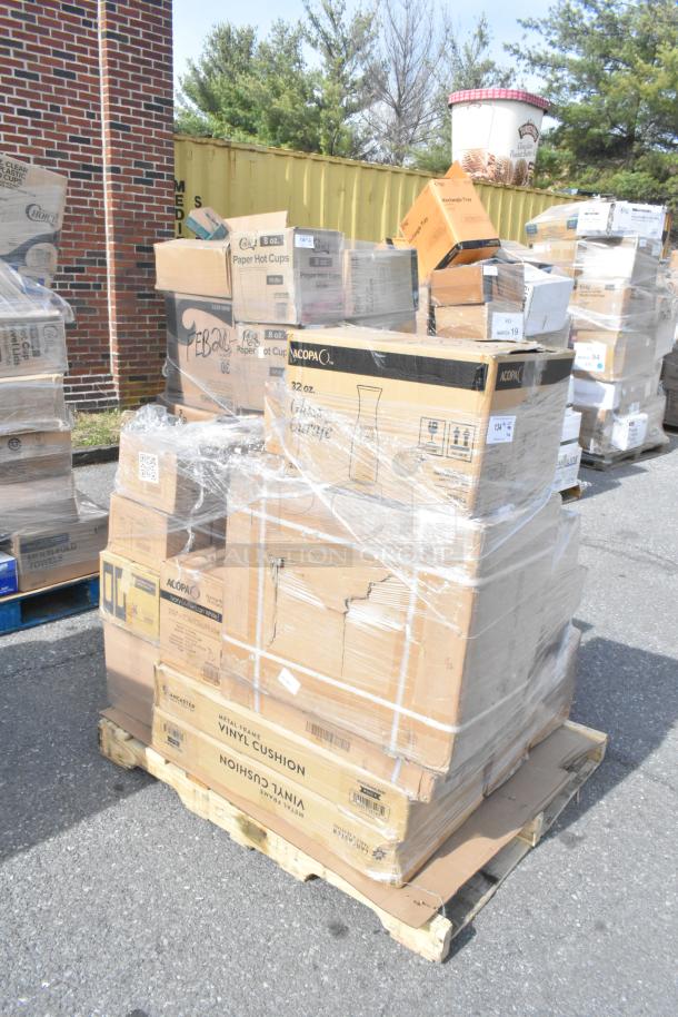 Pallet with assorted boxes of kitchen items, including fry pans and vases, labeled "scratch and dent," on a wooden base.